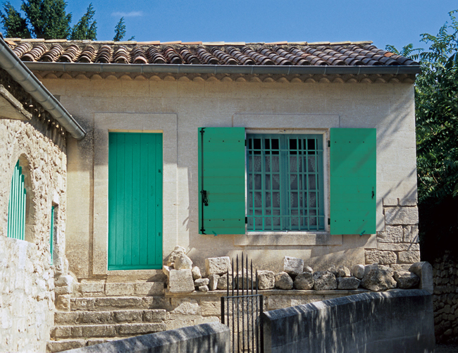 Volet battant vert sur une façade provençale en pierre